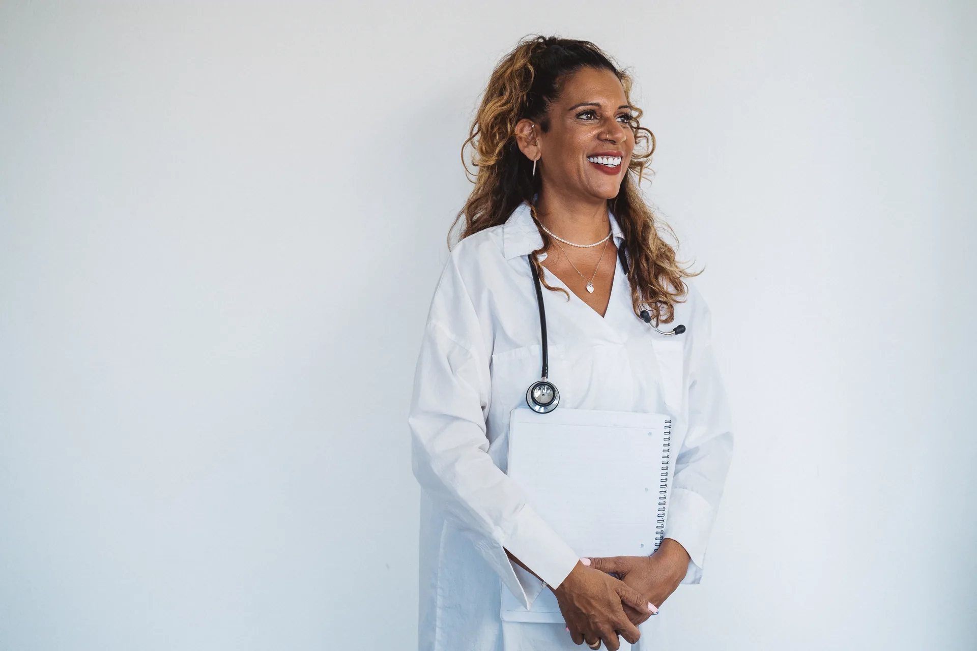 Confident healthcare professional in a white coat for Nursigo nursing exam success